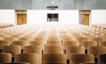 Empty chairs in a college classroom