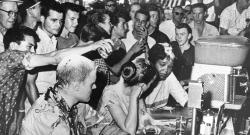Jackson, MS, Woolworth Lunch Counter Sit-In —white men pouring sugar on the heads of protestors and a woman of color