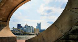 Pittsburgh skyline seen through the Fred Rogers Memorial Monument in foreground