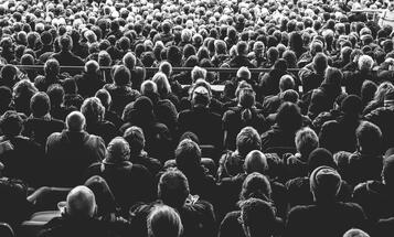 Black and white photo of a crowd from behind