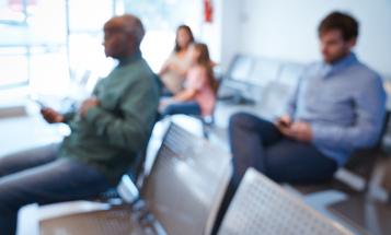 Defocused image of people sitting in an agency waiting room