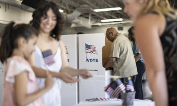 A diverse group of people voting at the local community center