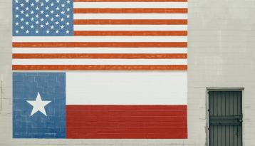 US Flag and Texas Flag Painted on big brick wall
