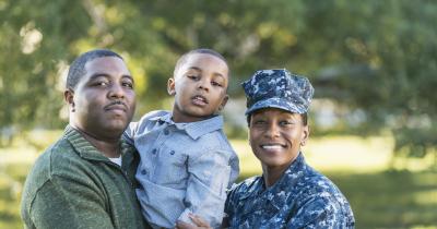 Black family smiling and posing together