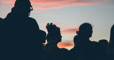 Group of people backlit at sunset