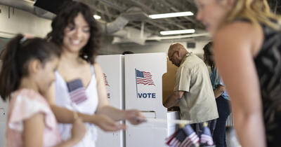 A diverse group of people voting at the local community center