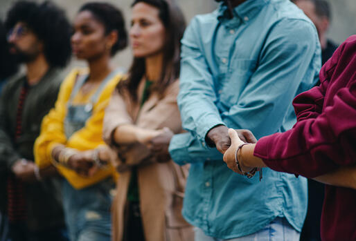 Multiracial group holding hands